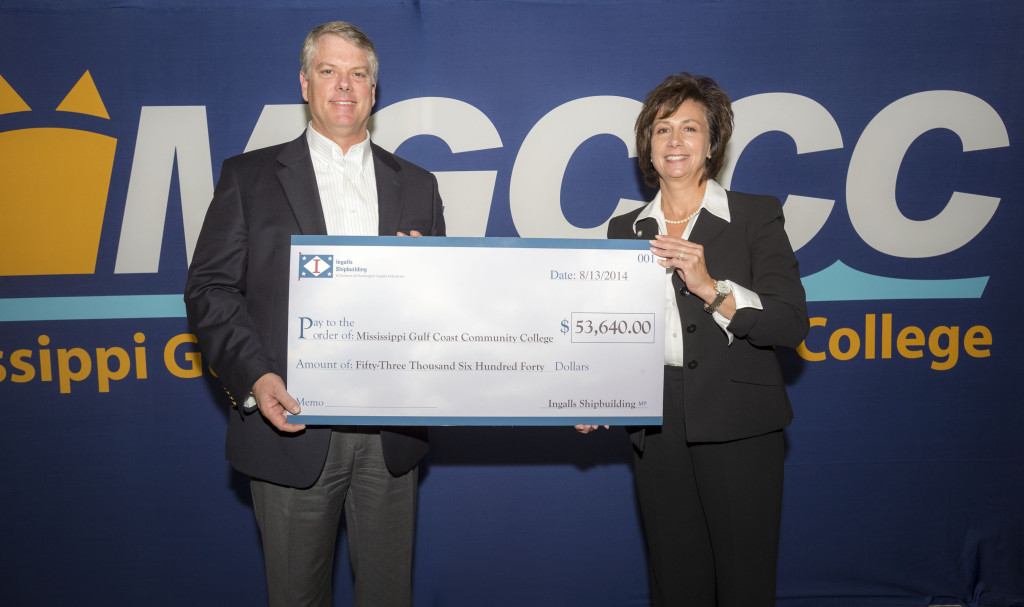 Ingalls Shipbuilding president Brian Cuccias, left, and Dr. Mary S. Graham, MGCCC president, hold the check representing the donation Ingalls made to purchase welding machines for MGCCC’s Transitions Academy.